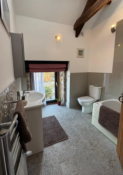 A bathroom with a stone-framed window