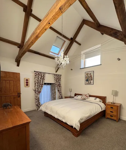 The master bedroom, under the vaulted beams