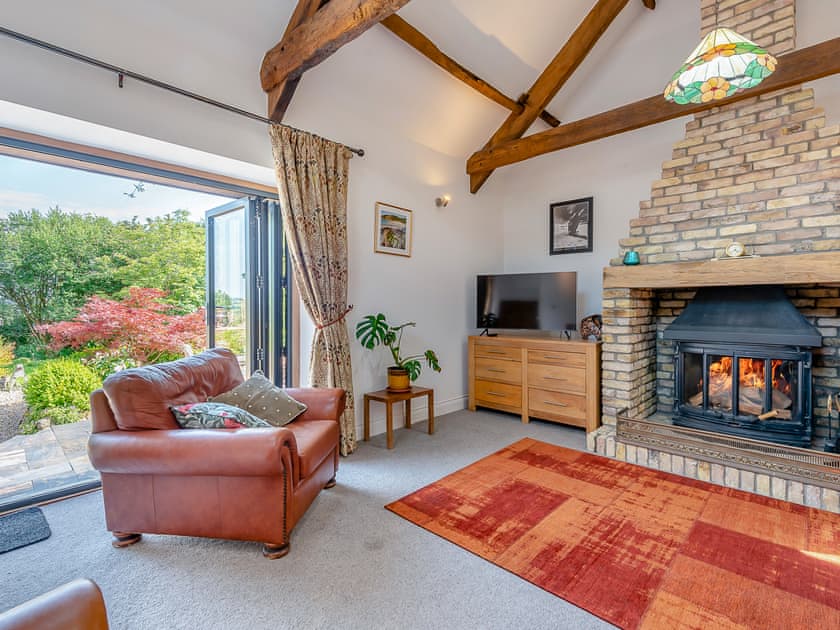 The vaulted living room with woodburner