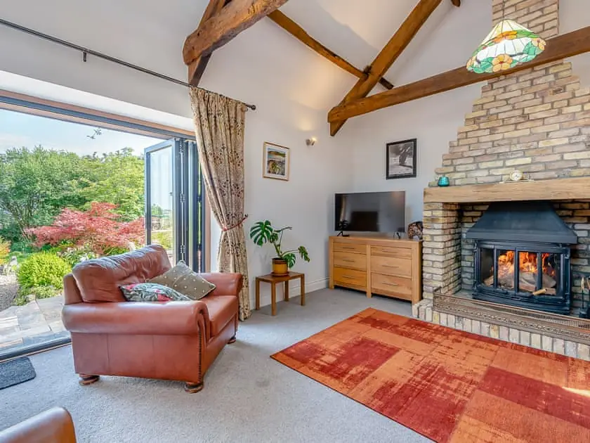 The vaulted living room with woodburner